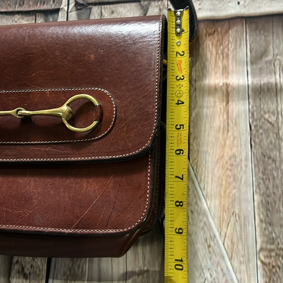 brown leather and features the gold-toned horsebit hardware.  B36 - Picture 3 of 9